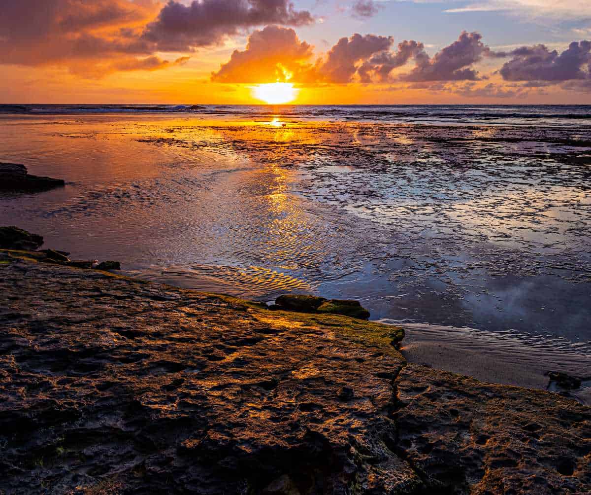 Witnessing sunset at Ke'e Beach is one of the top reasons to visit Haena State Park in Kauai, Hawaii