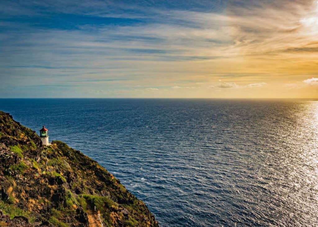 The rising sun illuminating the Makkapu Point Lighthouse