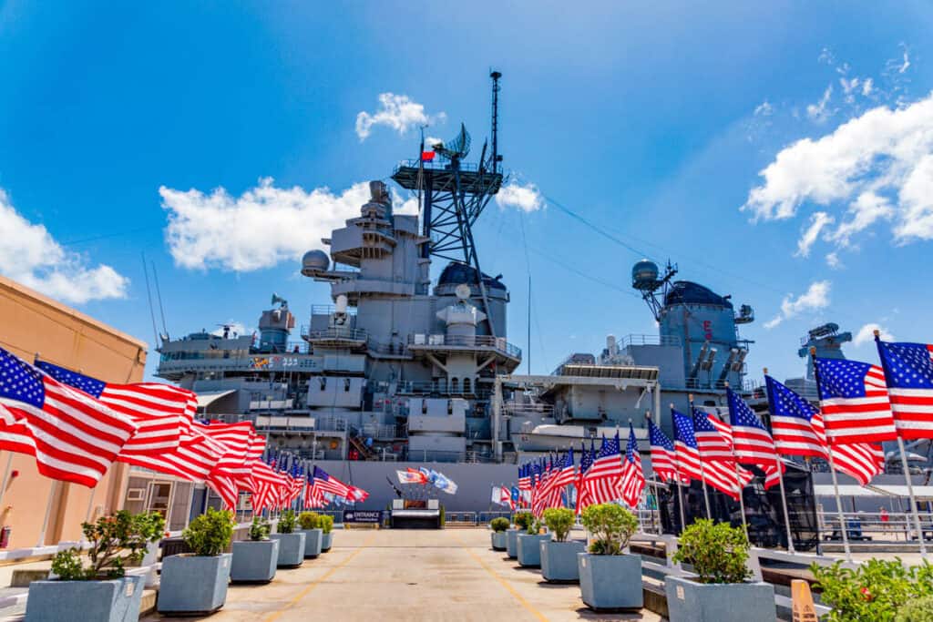 US flags fly at the Battleship Missouri Memorial in Pearl Harbor, Oahu