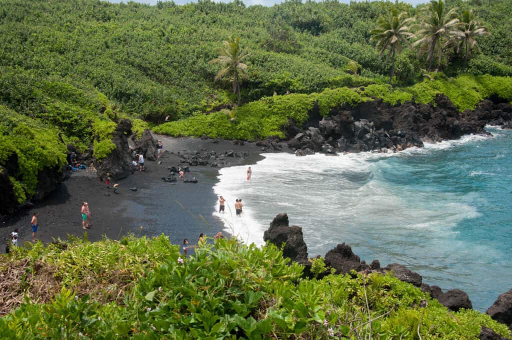 Looking down into the black sand beach at Waianapanapa State Park in Maui, HI