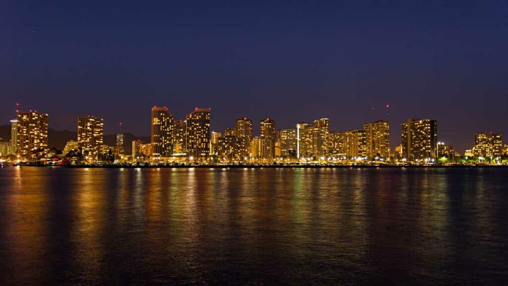 Honolulu skyline at night from a sunset dinner cruise, one of the most romantic things to do in Honolulu