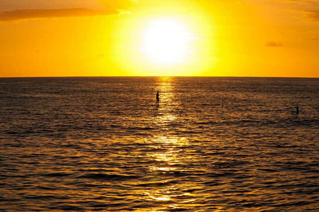 Standup paddleboarding at sunset in Hawaii