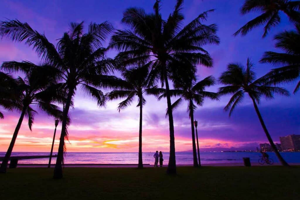 Watching the sun set on Waikiki Beach, one of the most romantic things to do in Waikiki, Honolulu, Hawaii