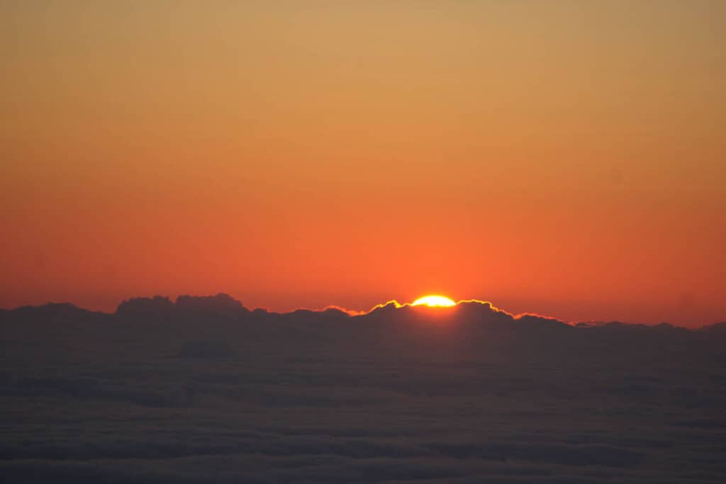 A view of the sun rising over the clouds at Haleakala in Maui