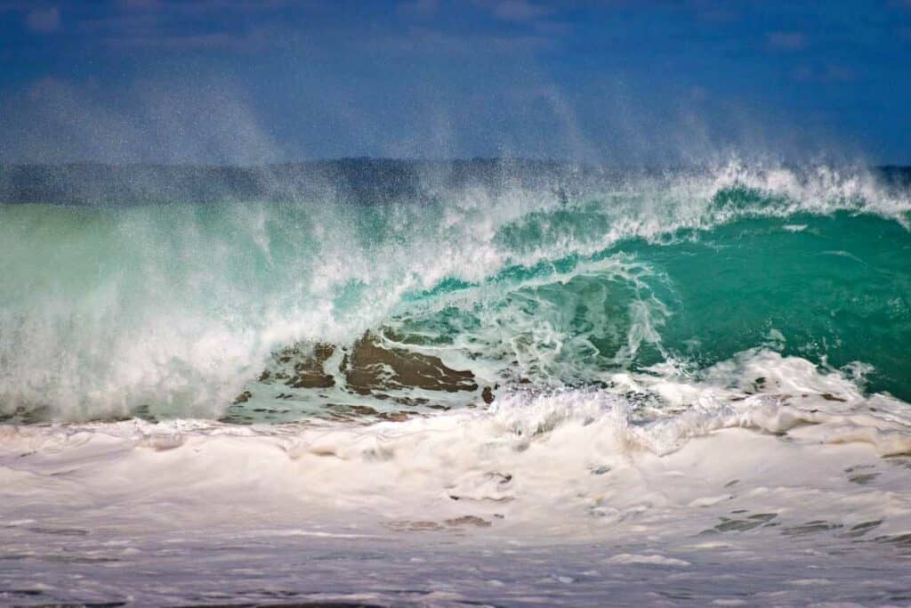 Large waves crashing at Hanakapiai Beach during high surf warning