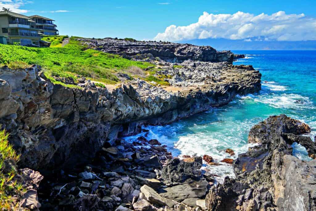 Cliffs, tidepools and Molokai Island in the distance at Hawea Point along the Kapalua Coastal Trail, Maui