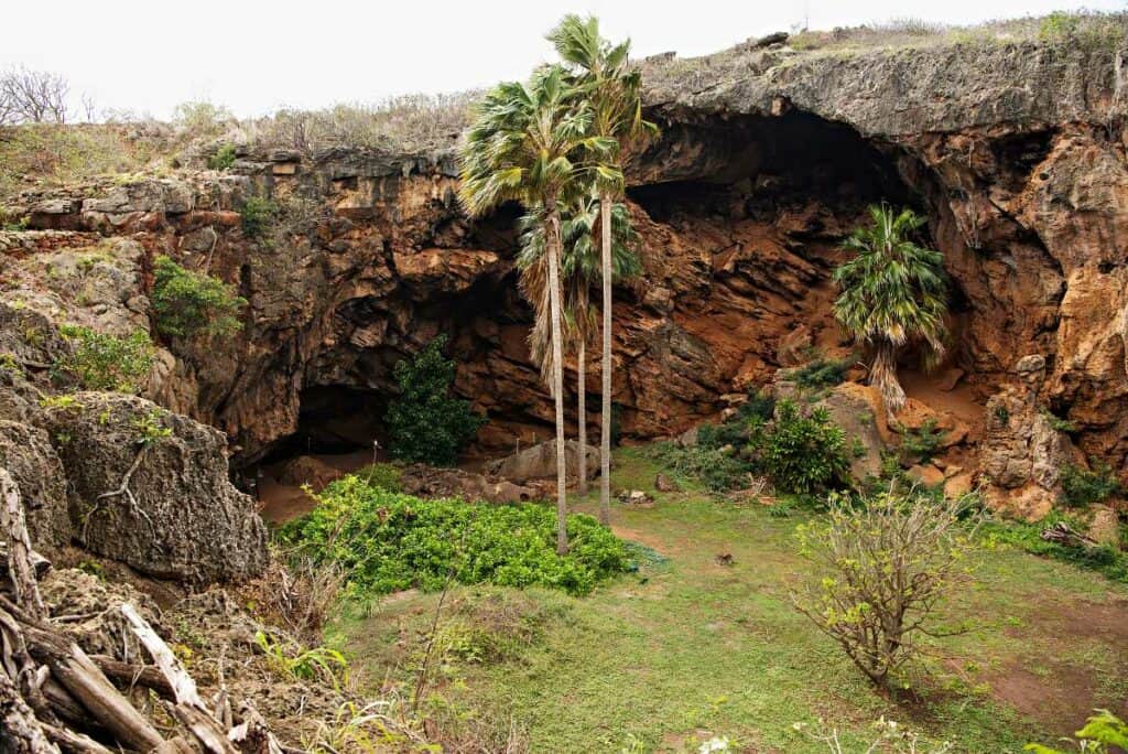 A sinkhole exposes the entrance to Makauwahi Cave near the Mahaulepu Heritage Coastal Trail, Poipu, Kauai