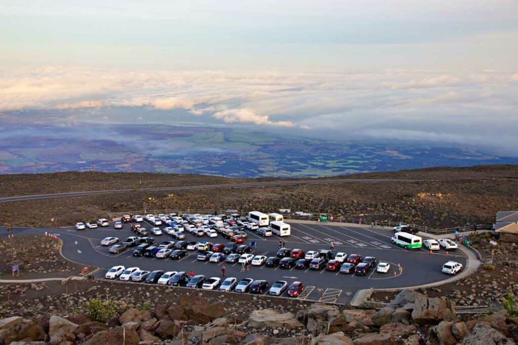Parking lot at Haleakala Crater with the Sliding Sands Trail trailhead near the road at the entrance to the lot