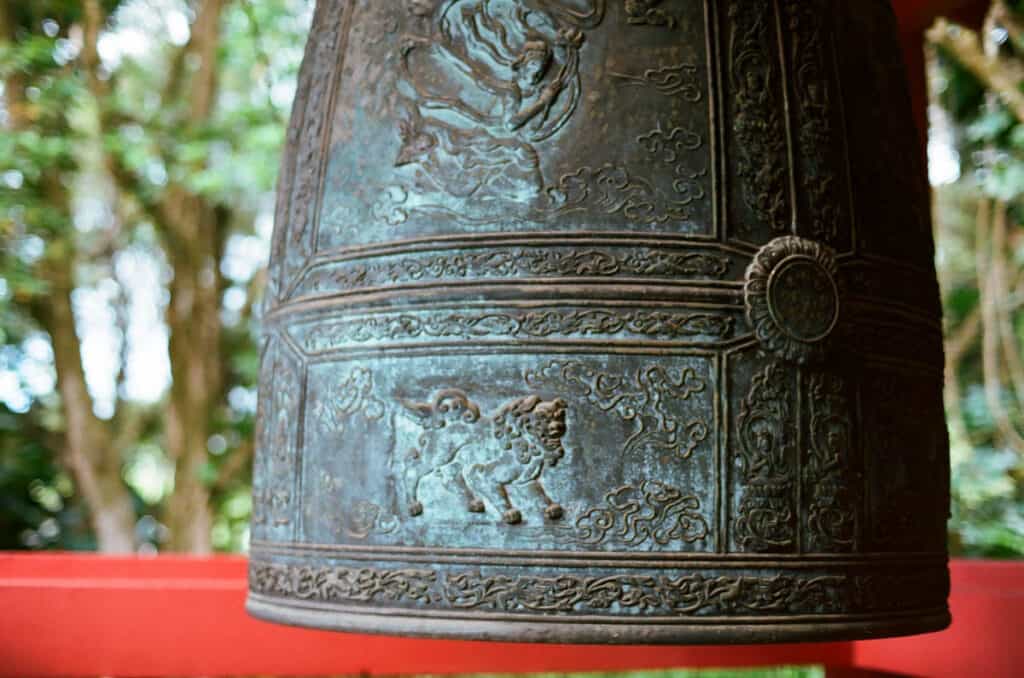 A close-up shot of the large bell at the Byodo-In Temple in Oahu, Hawaii
