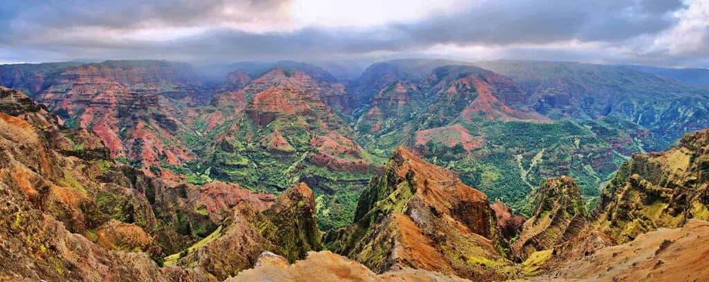 Panoramic view highlighting the red and green landscape from the Kukui Trail, one of the hardest Waimea Canyon hikes.
