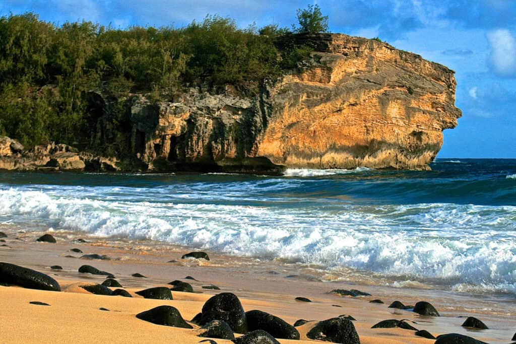 The cliff jump at Shipwreck Beach in Kauai, Hawaii