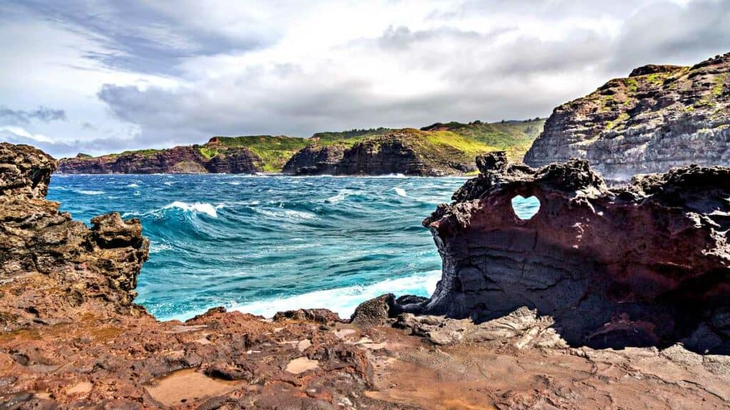 Natural, heart-shaped hole formation at Nakalele Blowhole in Maui, one of the best blowholes in Hawaii