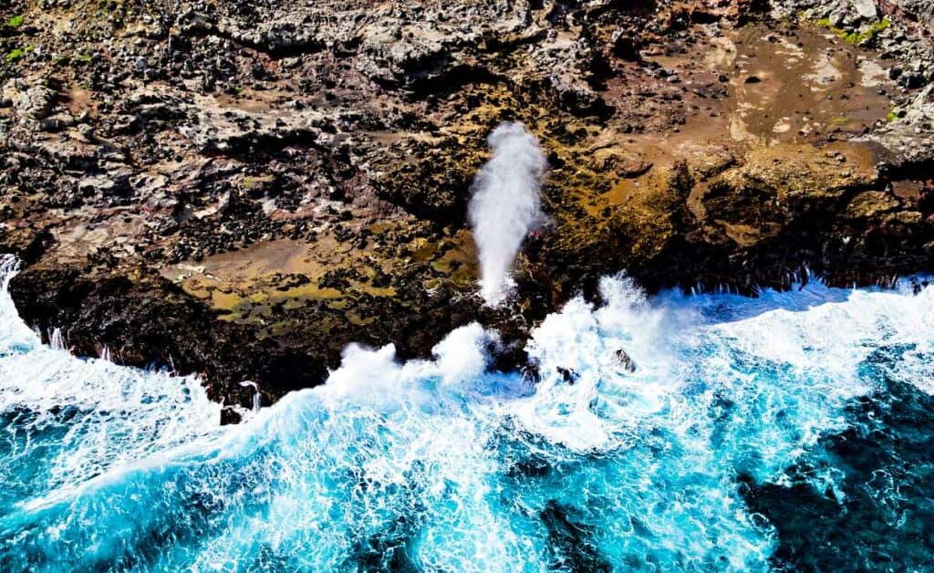 Aerial view of the Nakalele blowhole, one of the best Hawaii blowholes on Maui, showing high tide waves