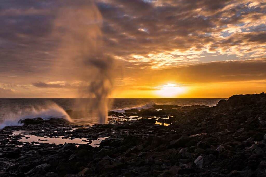 Colorful sunset at Spouting Horn Blowhole, one of the best Hawaii blowholes