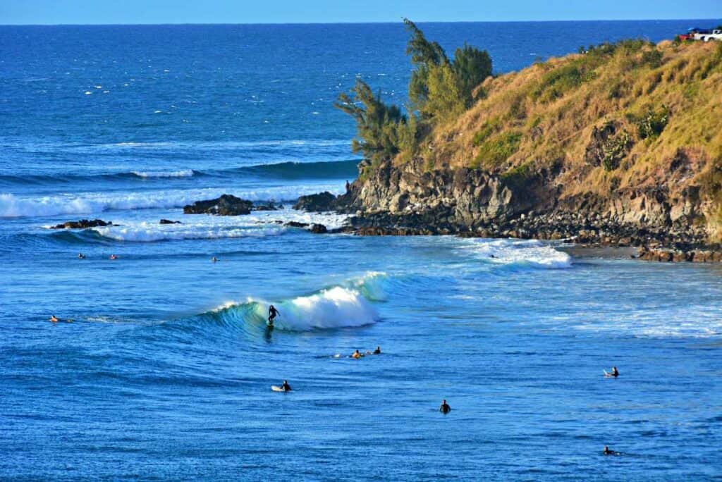 Surfers in Honolua Bay, Maui, HI, waiting for the right waves to ride