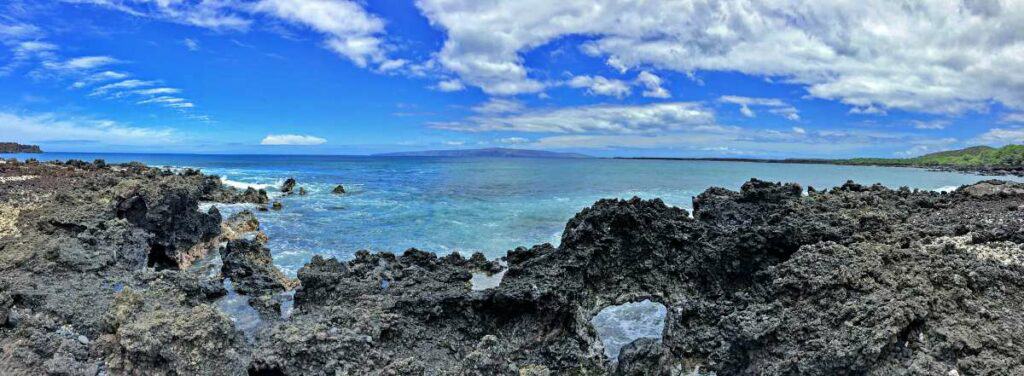 Lava rocks and coral reefs at the end of Maluaka Beach, Maui, HI