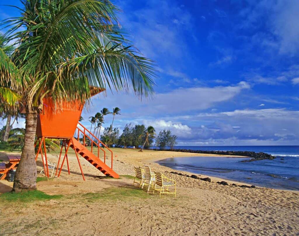 Red lifeguard station on Poipu Beach, one of the best family friendly beaches on Kauai, Hawaii