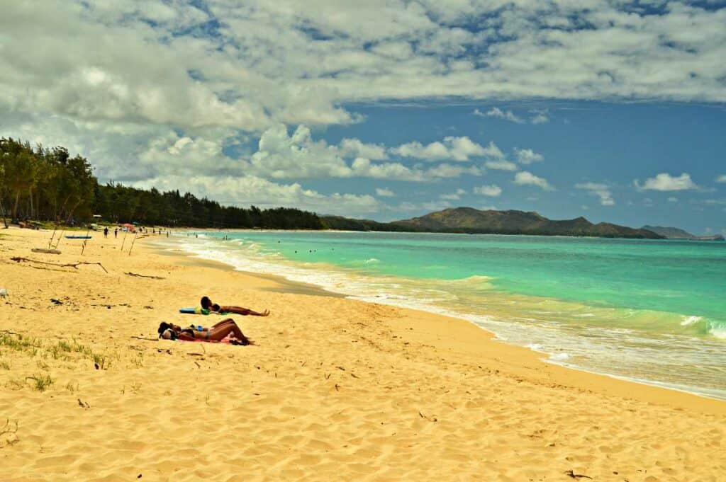 Sunbathers relaxing on the finely powdered white sands of Kailua Beach, Oahu, HI