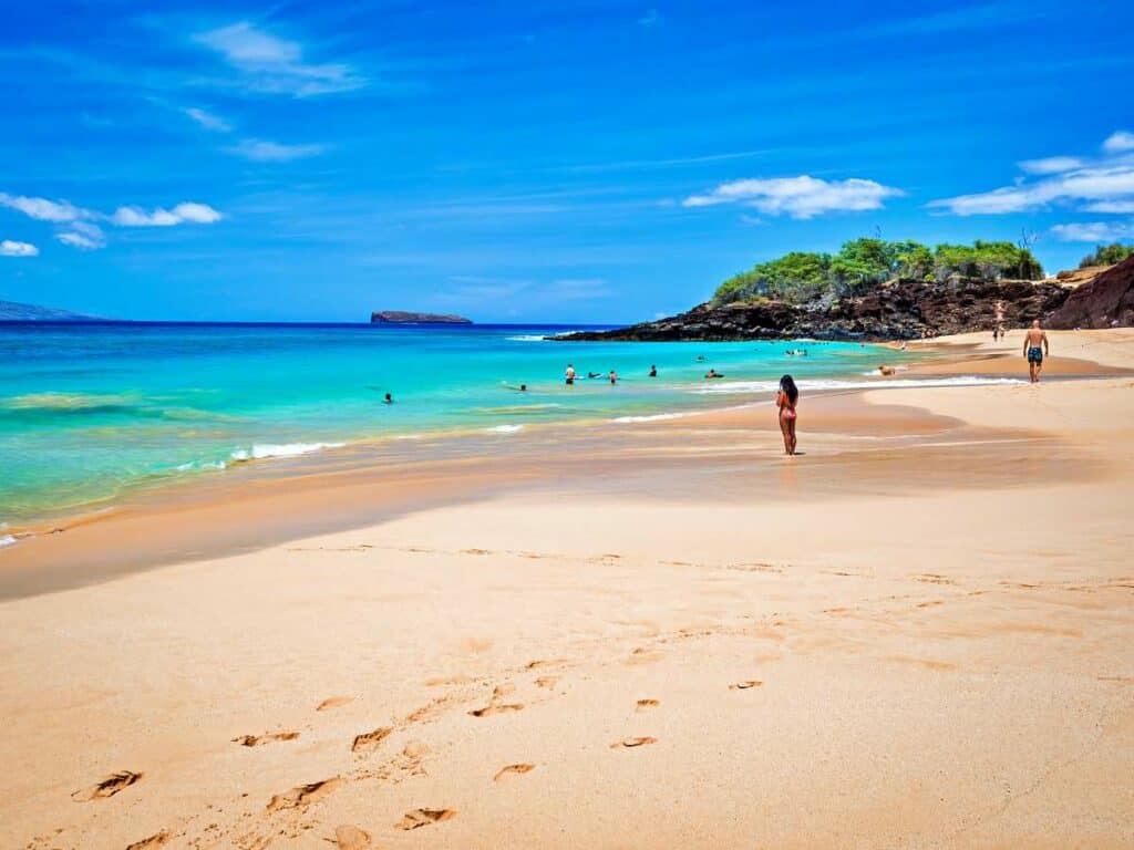 People enjoying wading and swimming on a calm day at Makena Beach (Big Beach), Maui, HI