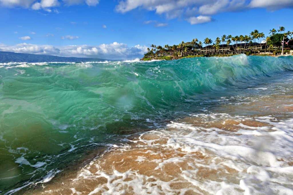 Towering waves breaking near the shore at Napili Bay, Maui, Hawaii