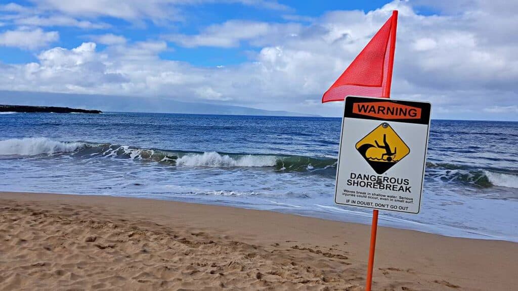 Sign warning that large waves can break near the shore, Napili Bay Beach, Maui, HI