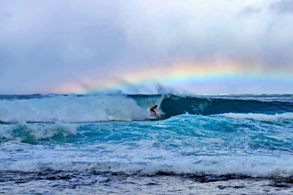 Surfing the towering waves on Haena Beach in winter, Kauai, Hawaii