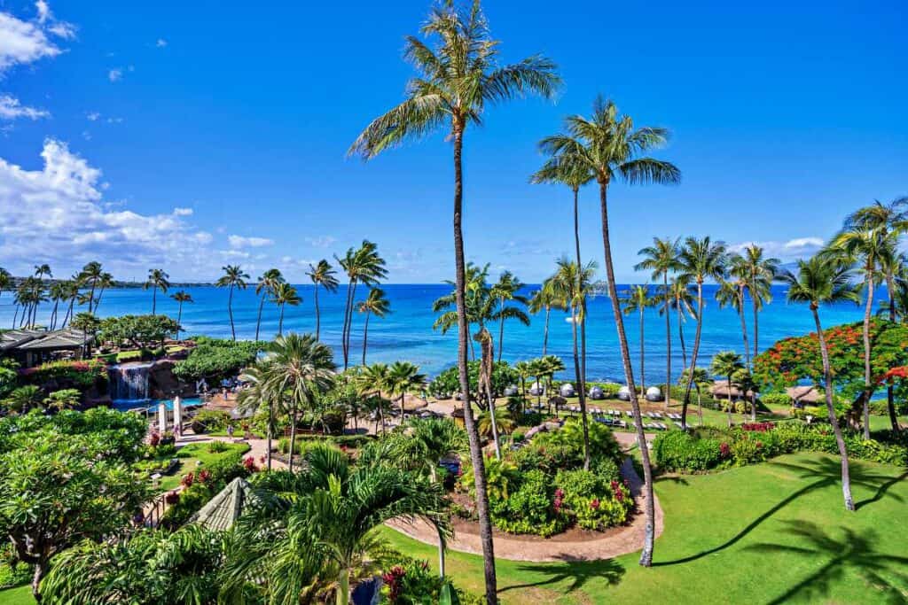 Intense blue ocean waters against manicured resort lawns at Ka'anapali Beach, Maui, Hawaii