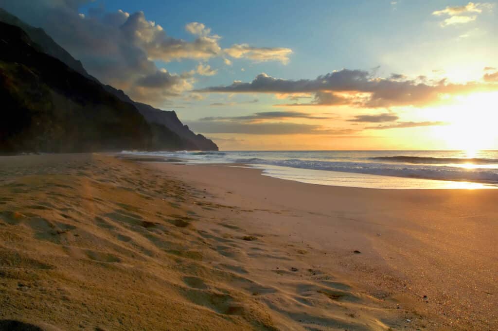 Enjoy a secluded sunset at Kalalau Beach in Kauai, Hawaii