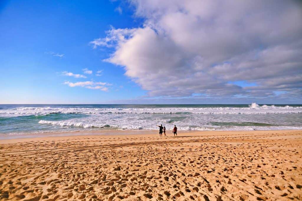 Long, wide beach, with plenty of space for a leisurely stroll at Ehukai Beach, Oahu, HI