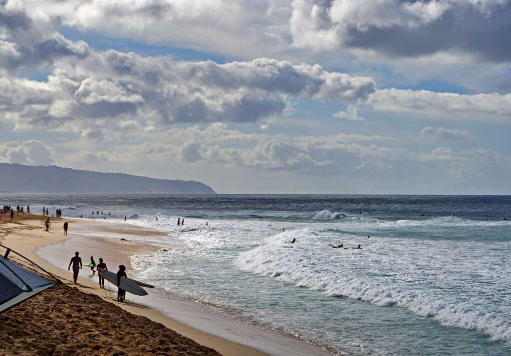 Kids enjoying the summer waves at Ehukai Beach, Oahu, Hawaii