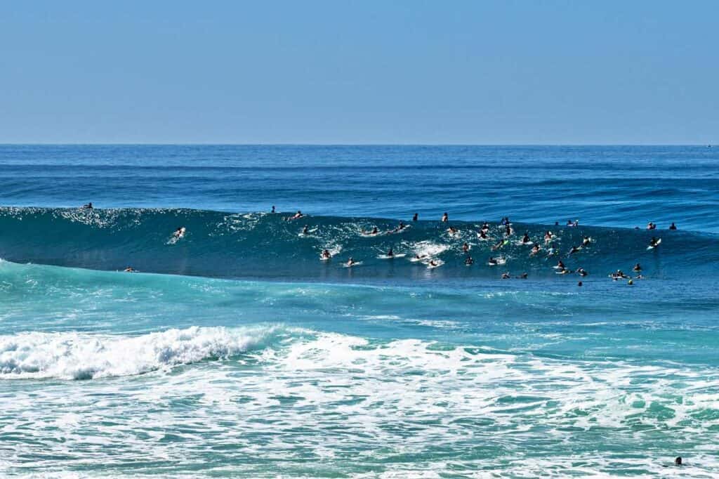 Pro surfers waiting for a big wave to ride on the Banzai Pipeline, Hawaii