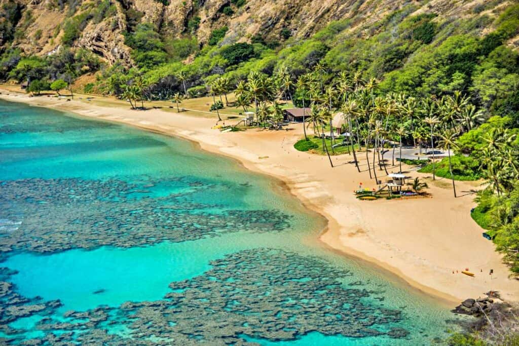 Clear blue waters, extensive coral reefs, and stunning beach at Hanauma Bay, Honolulu, HI