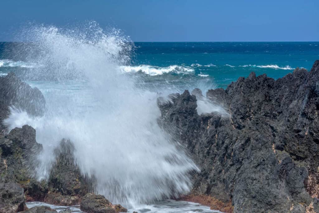 Waves crashing onto shore at Laupahoehoe Point Beach Park in Hawaii