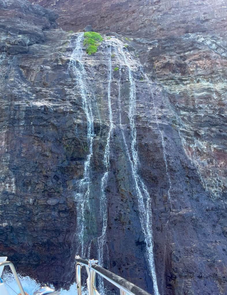 Na Pali Coast waterfall from boat in Kauai, Hawaii